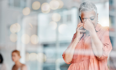 Image showing Stress, headache and phone call of senior woman feeling pain, tired or exhausted. Bokeh window, mental health or ceo with depression, anxiety or migraine while talking on mobile with bad news mockup.
