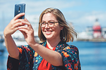 Image showing Selfie, travel and woman with phone by harbor enjoying vacation, holiday and journey in Amsterdam. Freedom, adventure and happy female take picture for social media, post and memory on smartphone