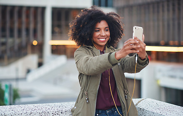 Image showing Black woman, city and selfie with smile, smartphone and happiness for social media profile picture. Happy gen z girl, african and phone for blog, post or networking app on rooftop balcony for travel