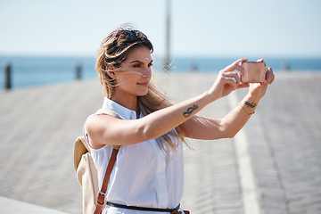 Image showing Travel, selfie and woman relax at beach, calm and posing for photo on blurred background. Sightseeing, girl and social media influencer with update post for blog, profile picture or live streaming