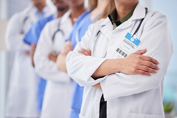 Image showing Doctors team, arms crossed and cropped at hospital with teamwork, diversity and solidarity for healthcare. Doctor, nurse and group for motivation, service and collaboration in clinic for wellness