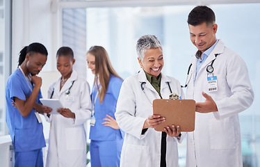 Image showing Doctors team, man and woman with checklist, smile and happy for results, progress or feedback in clinic. Doctor, nurse and diversity with paperwork, tablet and happiness for team building in hospital