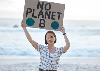 Image showing Protest, climate change and woman with a sign on the beach to stop pollution and global warming. Political, earth activism and portrait of a Asian female leader with a board by the ocean for a march.