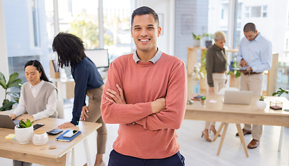 Image showing Portrait, startup and businessman or intern happy at new job or company in a modern office arms crossed with smile. Happy, confident and excited young male employee or worker at the workplace