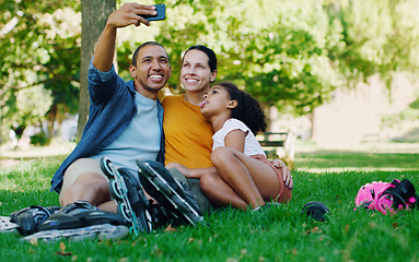 Image showing Interracial family selfie, girl and park with rollerblades, bonding or smile for profile picture, happy or holiday. Black man, mom and child for happiness, hug or diversity for social media on grass