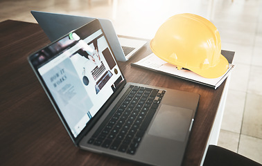 Image showing Laptop, hardhat and desk in an industry office for engineering architecture project planning. Industrial, construction and computer or technology for research with a safety helmet in the workplace.