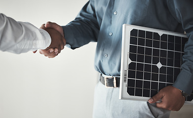 Image showing Closeup, handshake and business with solar panels, mockup and partnership for sustainability. Zoom, men and employees with gesture for collaboration, eco friendly or energy for electricity or meeting