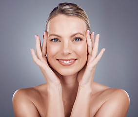 Image showing Skincare, woman and portrait in studio for beauty, dermatology and wellness cosmetics on background. Happy mature female model touch face for aesthetic glow, shine and healthy facial transformation