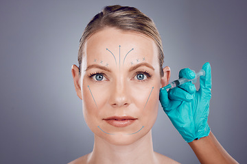 Image showing Woman, studio portrait and hands for plastic surgery, cosmetic transformation and beauty by gray background. Model, anti aging and headshot with injection, skincare and writing on face with surgeon