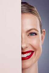 Image showing Half, mockup and portrait of a woman with makeup isolated on a grey studio background. Space, cosmetics and face of a young, smiling and confident happy model with cosmetic glamour on a backdrop