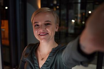 Image showing Business, night and woman with selfie, smile and cheerful in modern office, workaholic and overtime. Portrait, dark and female employee with happiness, new deal and overtime for project and planning