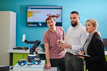 Image showing A group of students working together in a laboratory, dedicated to exploring the aerodynamic capabilities of a drone