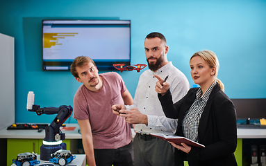 Image showing A group of students working together in a laboratory, dedicated to exploring the aerodynamic capabilities of a drone