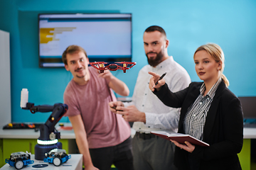 Image showing A group of students working together in a laboratory, dedicated to exploring the aerodynamic capabilities of a drone