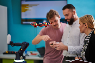 Image showing A group of students working together in a laboratory, dedicated to exploring the aerodynamic capabilities of a drone