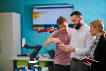 Image showing A group of students working together in a laboratory, dedicated to exploring the aerodynamic capabilities of a drone