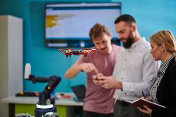 Image showing A group of students working together in a laboratory, dedicated to exploring the aerodynamic capabilities of a drone