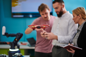Image showing A group of students working together in a laboratory, dedicated to exploring the aerodynamic capabilities of a drone