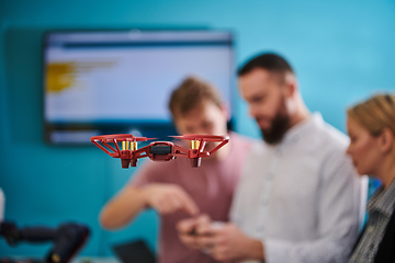 Image showing A group of students working together in a laboratory, dedicated to exploring the aerodynamic capabilities of a drone