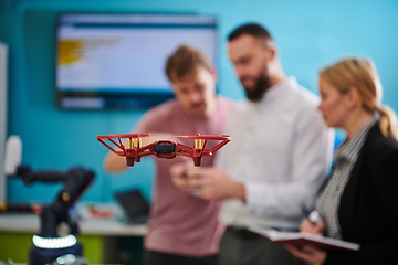 Image showing A group of students working together in a laboratory, dedicated to exploring the aerodynamic capabilities of a drone