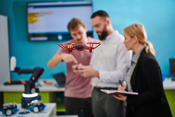 Image showing A group of students working together in a laboratory, dedicated to exploring the aerodynamic capabilities of a drone