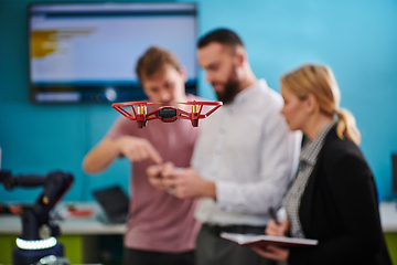 Image showing A group of students working together in a laboratory, dedicated to exploring the aerodynamic capabilities of a drone