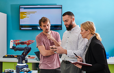 Image showing A group of students working together in a laboratory, dedicated to exploring the aerodynamic capabilities of a drone