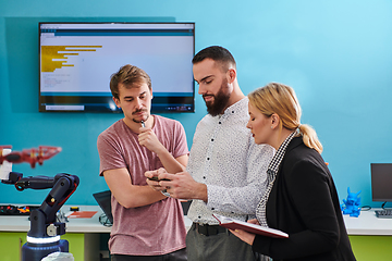 Image showing A group of students working together in a laboratory, dedicated to exploring the aerodynamic capabilities of a drone