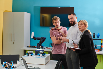 Image showing A group of students working together in a laboratory, dedicated to exploring the aerodynamic capabilities of a drone