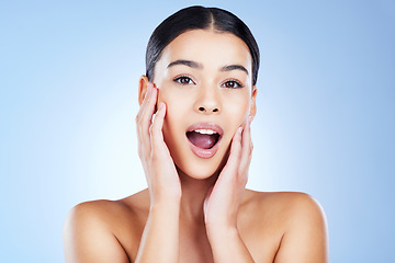 Image showing Skincare, shock and portrait of a woman in a studio with a beauty, natural and face routine. Surprise, health and female model from Brazil with a shocking facial treatment isolated by blue background