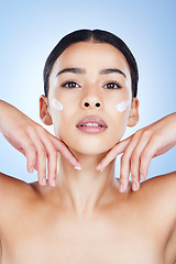 Image showing Woman, face and hands in skincare moisturizer, cosmetics or beauty against a blue studio background. Female cheeks with cosmetic product, lotion or cream for facial treatment or self love or care