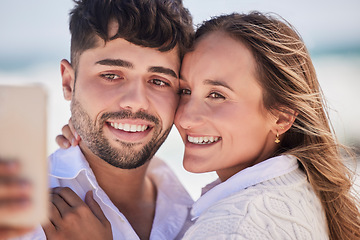 Image showing Selfie, love and couple on a date at the beach for valentines day, romance or anniversary in summer. Happiness, smile and young man and woman hugging while taking picture by the ocean on vacation.