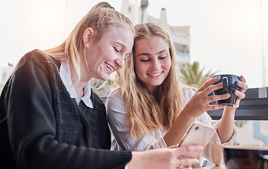 Image showing Friends, coffee shop and smile at meme on phone, laugh at joke online and women networking in cafe. Smartphone, technology and communication on internet website, students with cellphone in restaurant