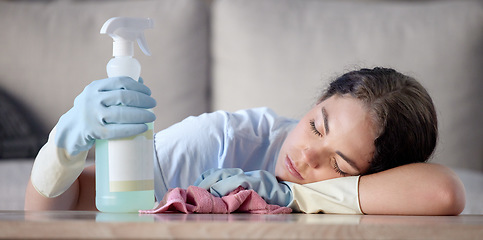 Image showing Tired woman, housekeeping and sleeping on table with detergent bottle by the living room sofa at home. Female exhausted from spring cleaning, burnout or nap after disinfection with sanitizer bottle