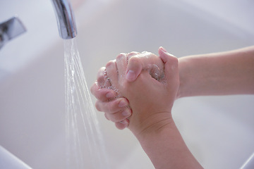 Image showing Hygiene, above and person washing hands with water for health, disinfection and virus protection. Soap, healthy and liquid from a basin to wash, clean and prevent disease on fingers of a human