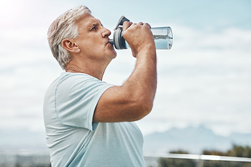 Image showing Senior man, fitness and drinking water for hydration or thirst after workout, exercise or training in nature. Elderly male having refreshing natural liquid drink from intense cardio in the outdoors