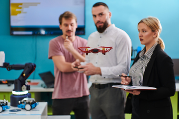 Image showing A group of students working together in a laboratory, dedicated to exploring the aerodynamic capabilities of a drone