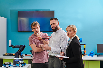 Image showing A group of students working together in a laboratory, dedicated to exploring the aerodynamic capabilities of a drone