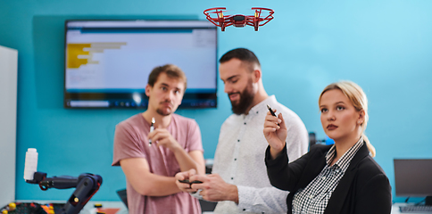 Image showing A group of students working together in a laboratory, dedicated to exploring the aerodynamic capabilities of a drone