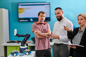 Image showing A group of students working together in a laboratory, dedicated to exploring the aerodynamic capabilities of a drone