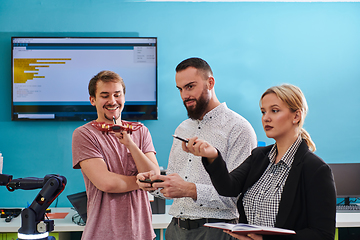 Image showing A group of students working together in a laboratory, dedicated to exploring the aerodynamic capabilities of a drone