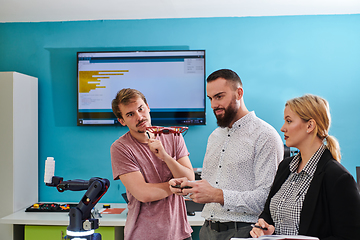 Image showing A group of students working together in a laboratory, dedicated to exploring the aerodynamic capabilities of a drone