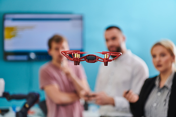 Image showing A group of students working together in a laboratory, dedicated to exploring the aerodynamic capabilities of a drone