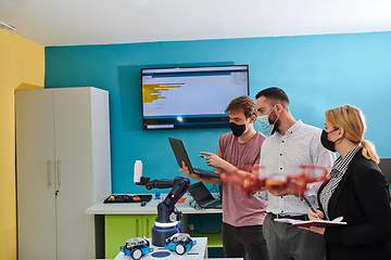 Image showing A group of students working together in a laboratory, dedicated to exploring the aerodynamic capabilities of a drone