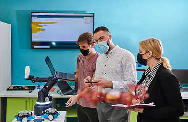 Image showing A group of students working together in a laboratory, dedicated to exploring the aerodynamic capabilities of a drone