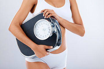 Image showing Woman, body and scale with fitness and health, diet or detox to lose weight with exercise, healthy lifestyle and wellness. Nutrition, workout and weightloss, healthcare isolated on studio background