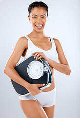 Image showing Black woman, body and scale with fitness and health, diet or detox to lose weight with exercise, healthy lifestyle and wellness. Nutrition, workout and weightloss portrait on studio background