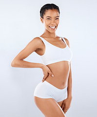 Image showing Health, smile and body care, portrait of woman in underwear with healthy diet and exercise in studio. Fitness, nutrition and skincare, wellness and model with slim figure isolated on grey background.