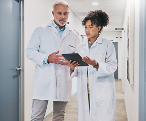 Image showing Doctors, tablet and clinic, healthcare team and communication, digital medical document or test results. Partnership, private practice and senior man with black woman, conversation and tech in health