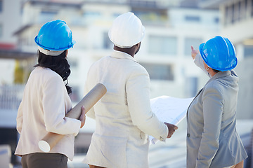 Image showing Engineering, collaboration or team on construction site with an blueprint for real estate development. Industrial, architecture or back view of group planning a building renovation project in meeting